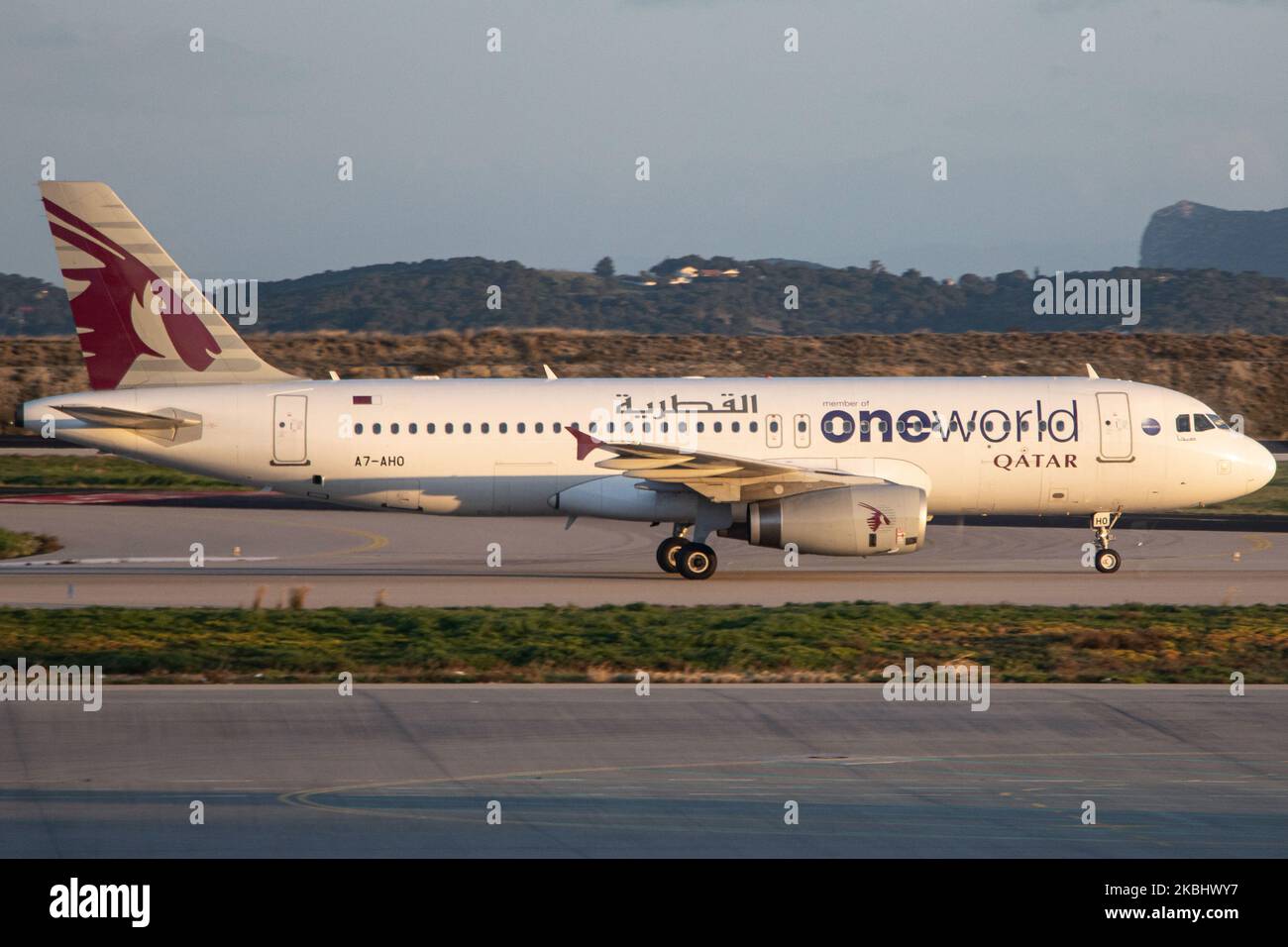 Qatar Airways Airbus A320 aircraft as seen landing and taxiing at Athens International Airport Eleftherios Venizelos ATH LGAV in Greece during the magic hour after the sunset. The airplane is an Airbus A320-200 with registration A7-AHO, 2x IAE jet engines and is painted with a special livery scheme ONEWORLD, the aviation alliance Qatar belongs. The state owned flag carrier airline QTR QR Qatari connects the Greek capital to Doha Hamad International Airport on a daily basis. February 16, 2020 (Photo by Nicolas Economou/NurPhoto) Stock Photo