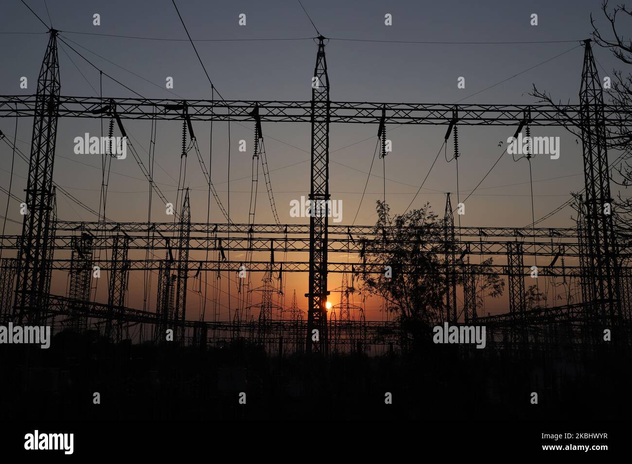 Sun sets behind a power grid (Electricity Station) in Jammu city on 25