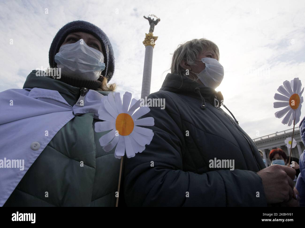 Ukrainian medical workers wearing face masks participate at a rally against health reform, on the Independence Square in Kyiv, Ukraine, on 26 February, 2020. Ukrainian nurses, doctors and other healthcare workers held their rally with demand better wages and working conditions, and against closing of medical facilities, according to local media. (Photo by STR/NurPhoto) Stock Photo