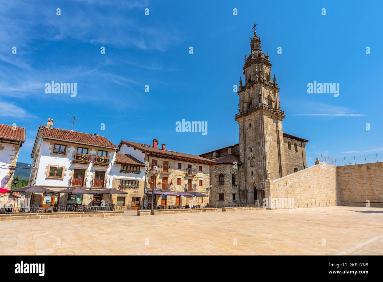 Otxandio, Spain. August 8, 2022. View of the Nagusia Square with some picturesque buildings and the Santa Marina church Stock Photo