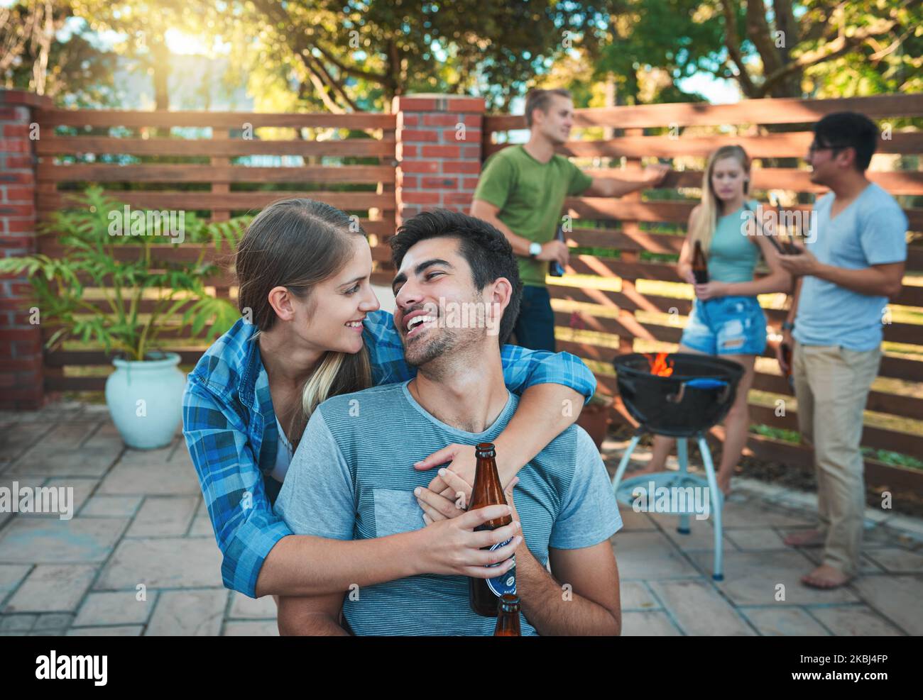 Coupled up at a cookout. an affectionate young couple enjoying ...