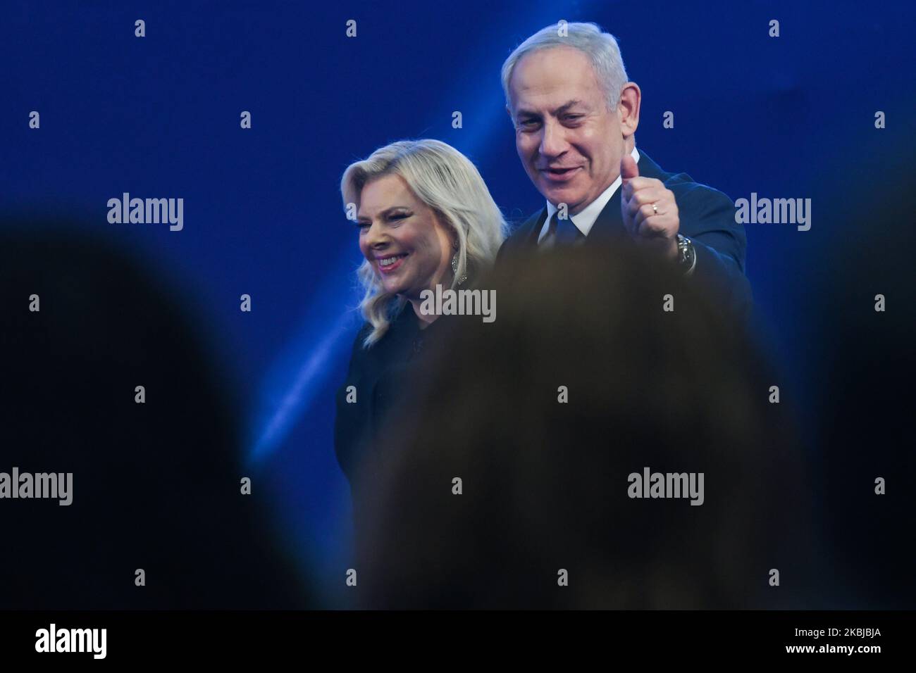 Israeli Prime Minister Benjamin Netanyahu walks and gestures next to his wife Sara on his way to speak to supporters following the announcement of exit polls in Israel's election at his Likud party headquarters in Tel Aviv. On Tuesday, March 3, 2020, in Tel Aviv, Israel. (Photo by Artur Widak/NurPhoto) Stock Photo