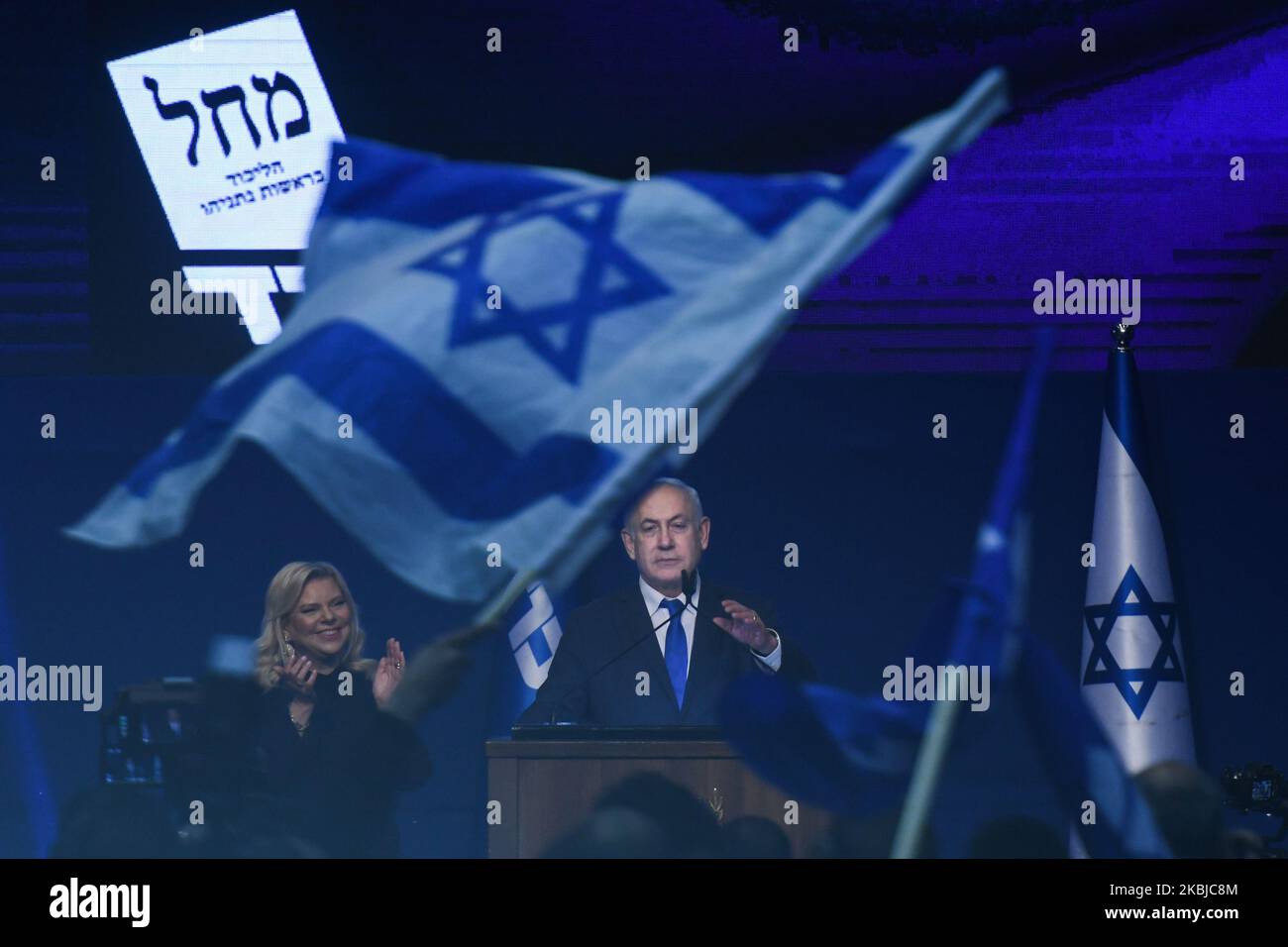 Israeli Prime Minister Benjamin Netanyahu stands next to his wife Sara as he speaks to supporters following the announcement of exit polls in Israel's election at his Likud party headquarters in Tel Aviv. On Tuesday, March 3, 2020, in Tel Aviv, Israel. (Photo by Artur Widak/NurPhoto) Stock Photo