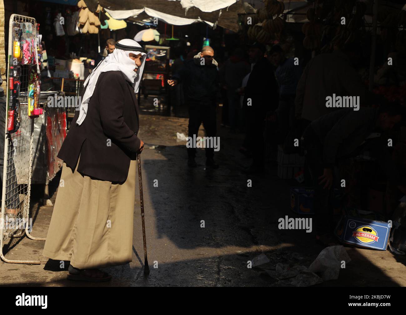 Palestinians walk in the market in Gaza City on March 4, 2020. (Photo by Majdi Fathi/NurPhoto) Stock Photo