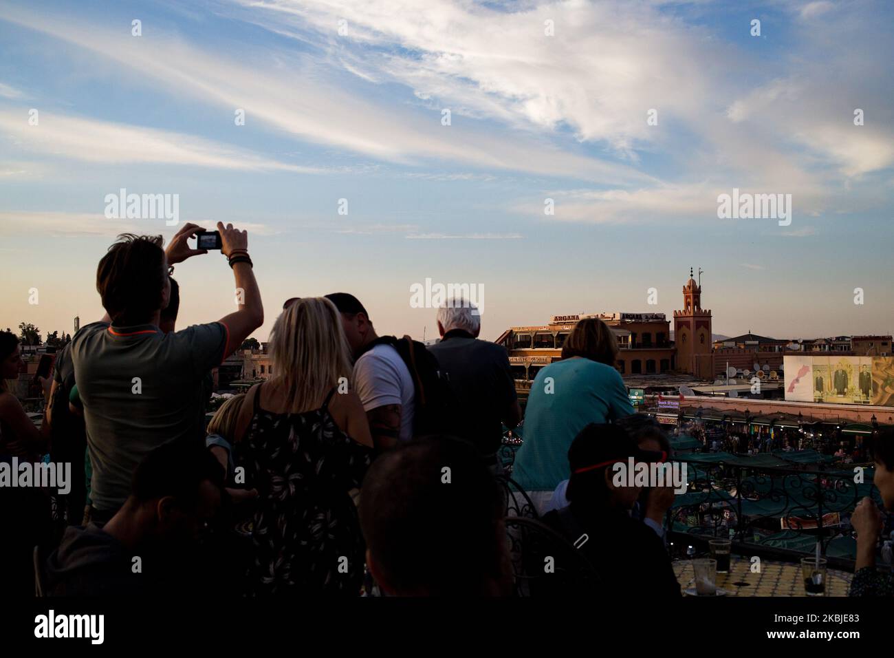 Marrakech, France, 19 October 2019. Tourists and locals enjoy the view of Jemaa el-Fna square from the cafe de glacier during sunset. (Photo by Emeric Fohlen/NurPhoto) Stock Photo