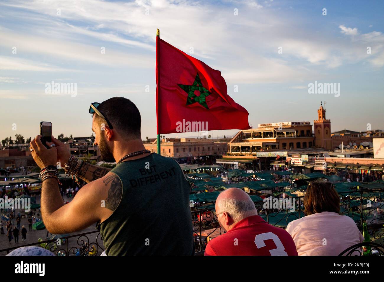 Marrakech, France, 19 October 2019. A tourist takes photos of Jemaa el-Fna square from the cafe de glacier during sunset. (Photo by Emeric Fohlen/NurPhoto) Stock Photo