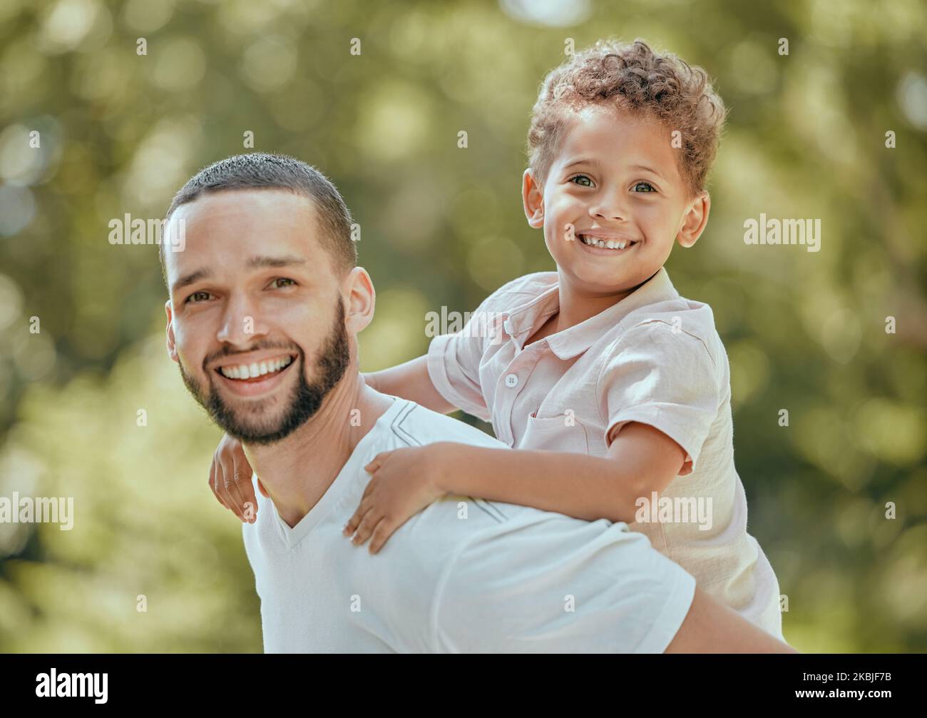 Dad, piggy back and child fun in nature with father and son bonding with quality time and happiness. Portrait of a happy dad and young kid together in Stock Photo