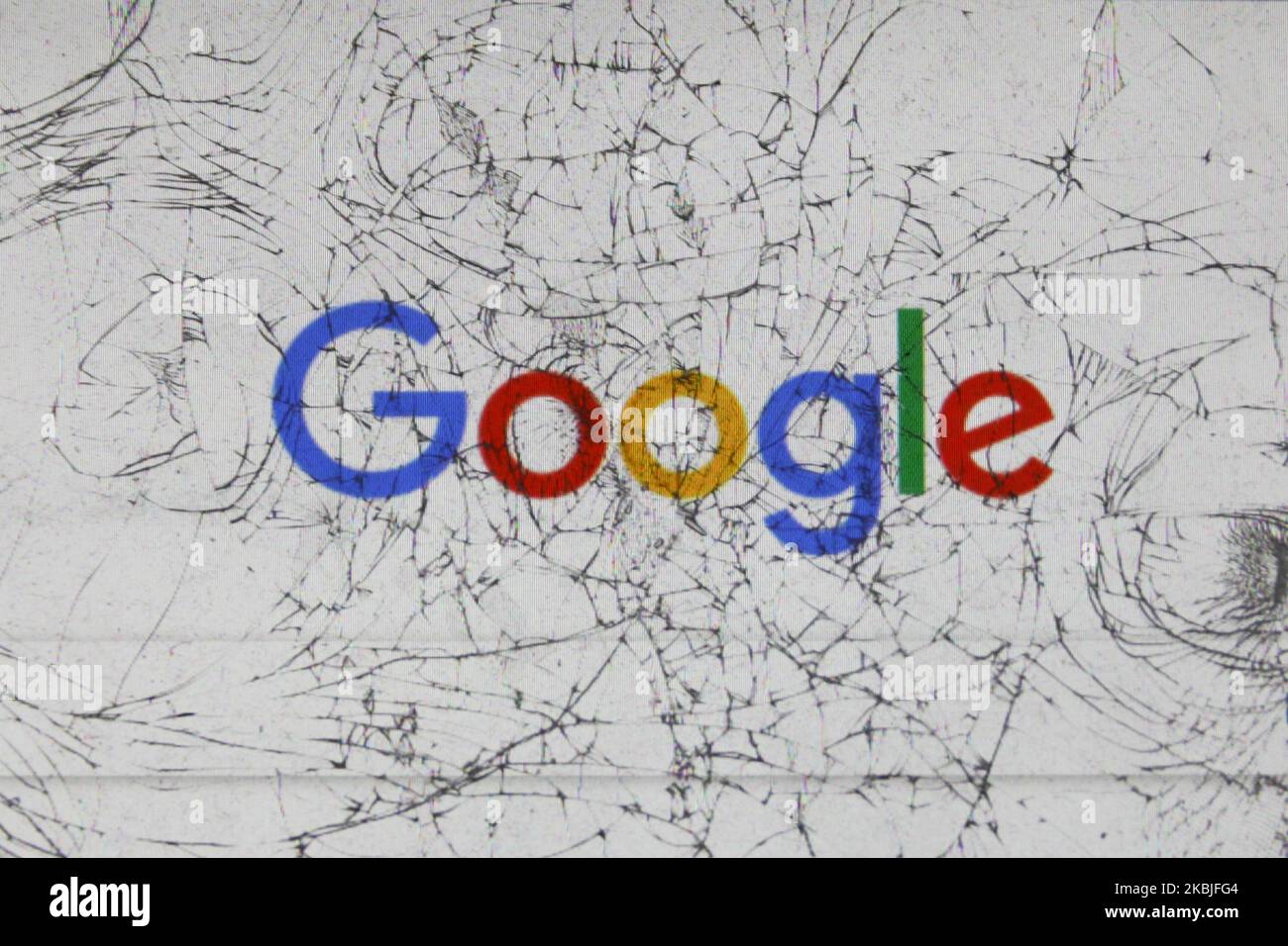 Google logo is seen through the broken glass in this illustration photo ...