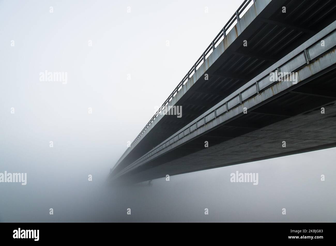 long bridge over water in fog Stock Photo Alamy