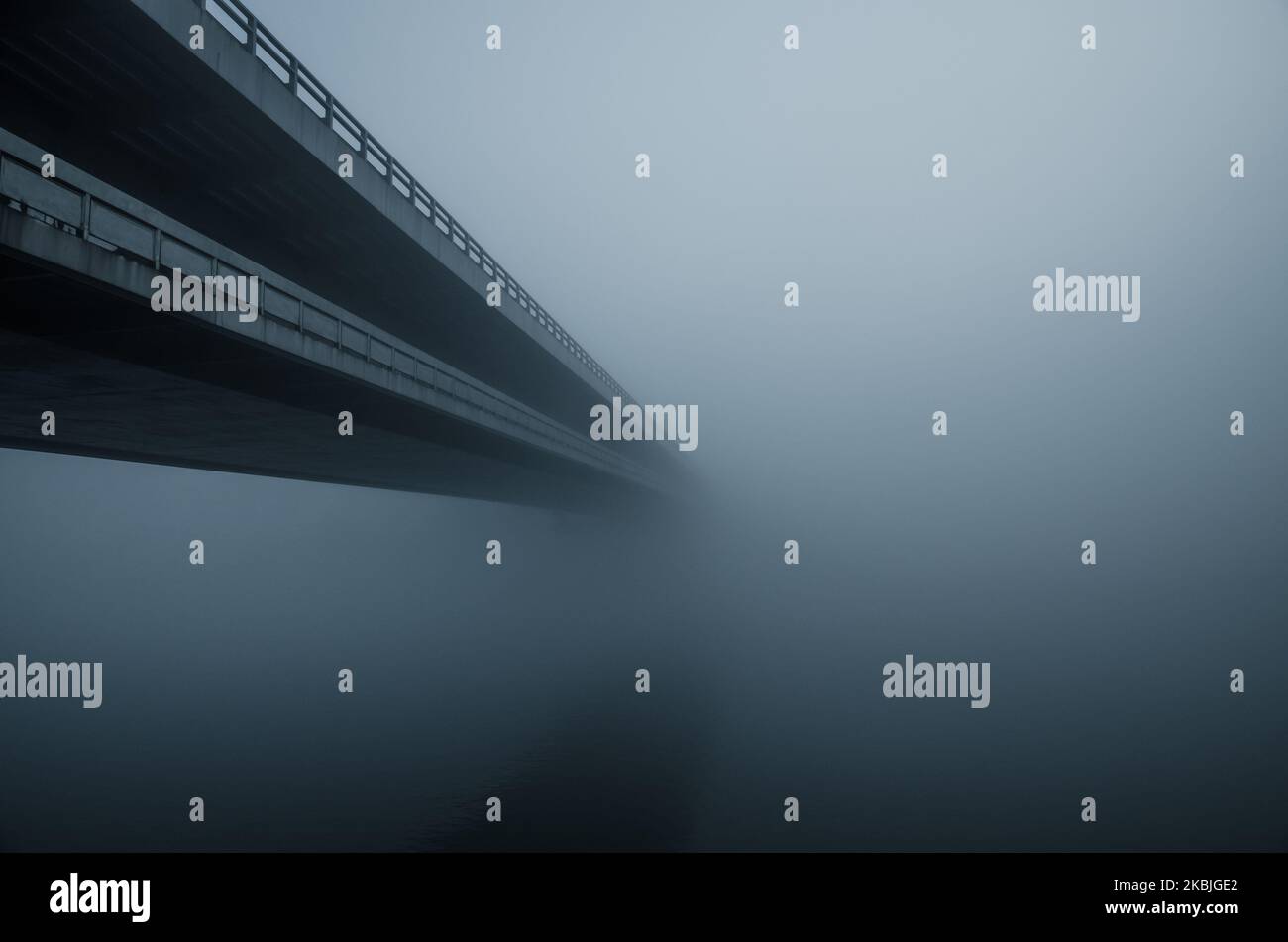 long bridge over water in fog Stock Photo Alamy