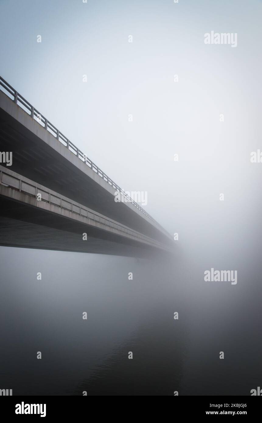 long bridge over water in fog Stock Photo Alamy