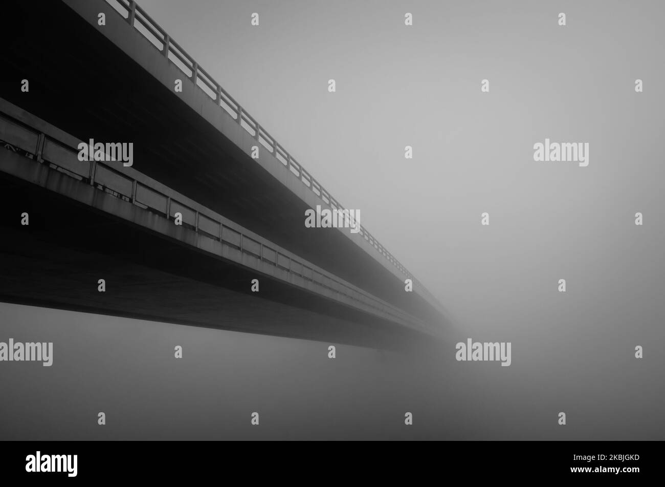 long bridge over water in fog Stock Photo Alamy