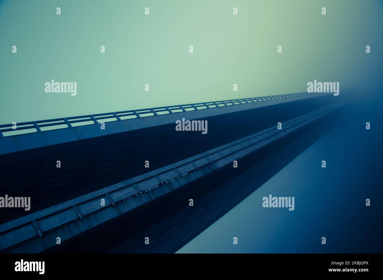 long bridge over water in fog Stock Photo Alamy