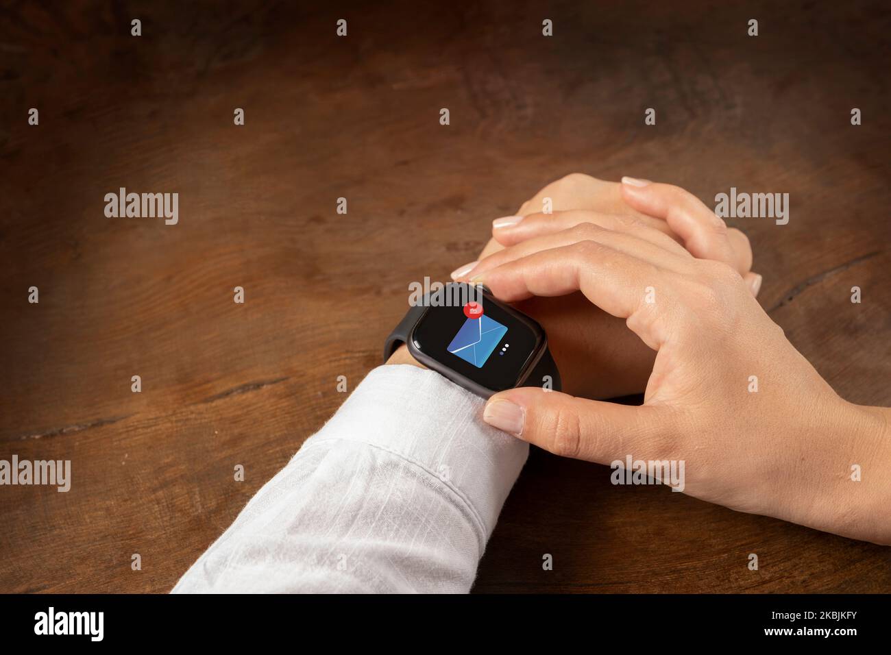 Woman hands checking unread emails from smartwatch. Over shoulder close