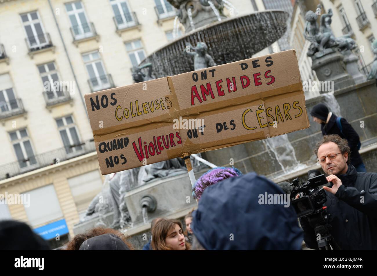 Demonstrator holding a sign denouncing the Polanski novel award at the Cesar 2020s while ''splicers'' of feminist posters are fined during the demonstration organized on the occasion of the International Day for Women's Rights on March 8, 2020 in Nantes, France. (Photo by Estelle Ruiz/NurPhoto) Stock Photo