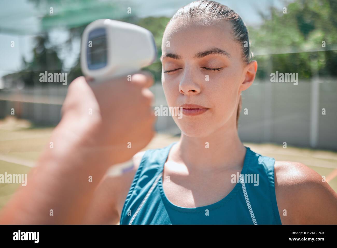 Woman, sports and healthcare test with thermometer for temperature, safety or check on the court