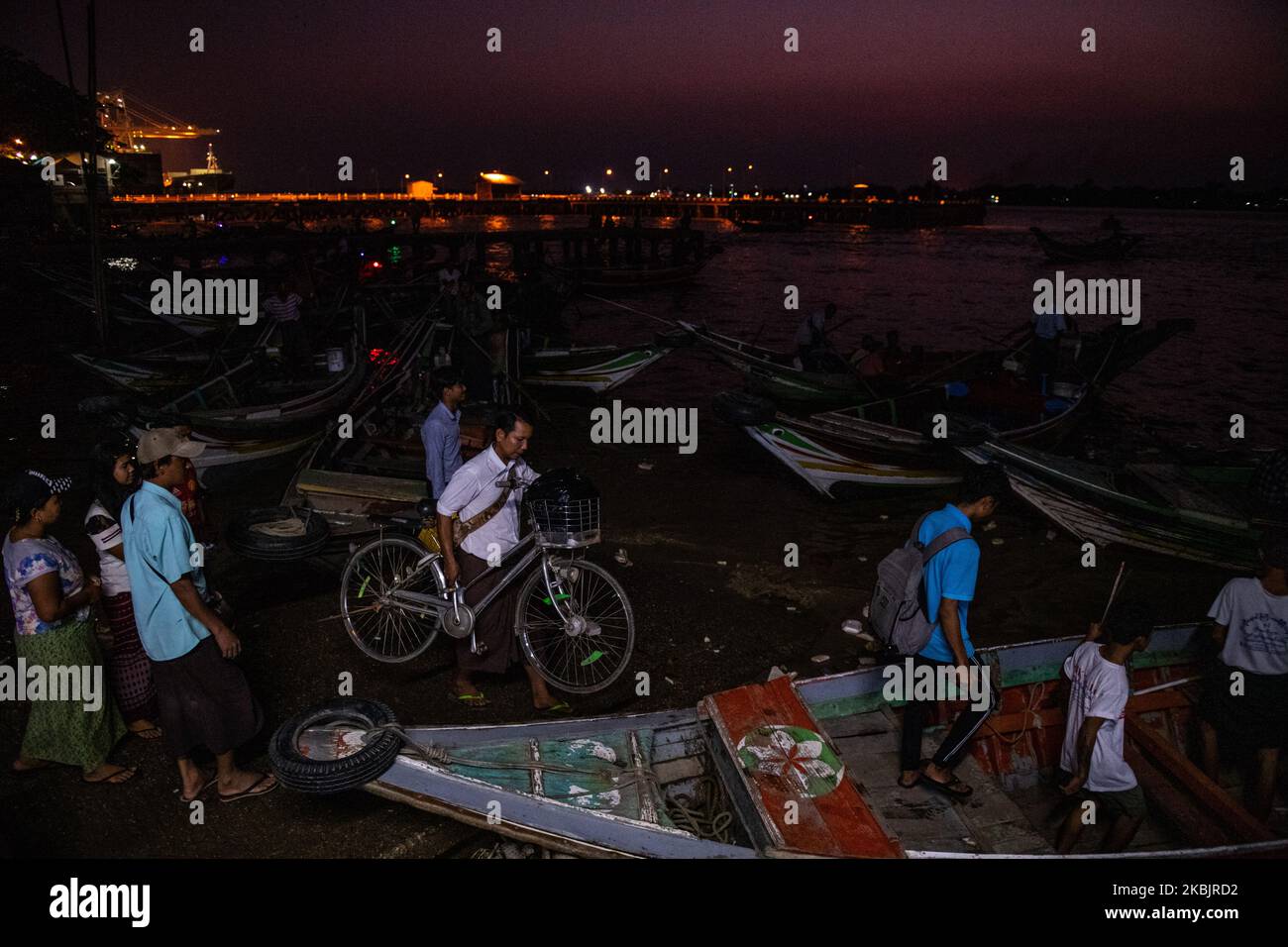 A man carries his bicycle on a ferry at a jetty in Yangon, Myanmar on March 10, 2020. (Photo by Shwe Paw Mya Tin/NurPhoto) Stock Photo