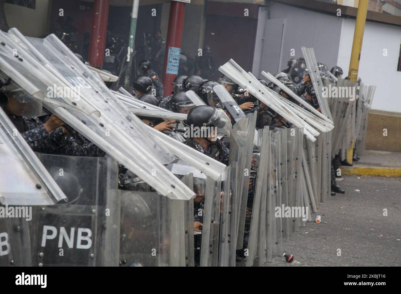 A large group of Venezuelan National Police officers block a street during a demonstration against the government of Nicolas Maduro organized by supporters of Juan Guaido on March 10, 2020 in Caracas, Venezuela. This demonstration is the first massive event called by Juan Guaido after his international tour which included a meeting with Donald Trump in Washington. (Photo by Rafael Briceno Sierralta/NurPhoto) Stock Photo