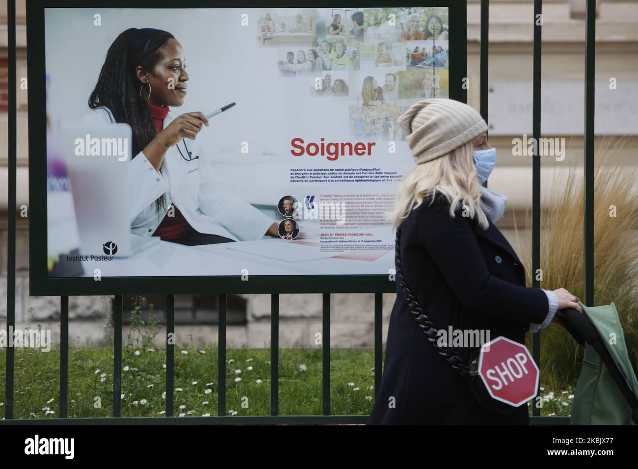 A woman with protective mask against coronavirus is walking in front of the Pasteur Institute in Paris, France, on March 12, 2020. (Photo by Mehdi Taamallah/NurPhoto) Stock Photo