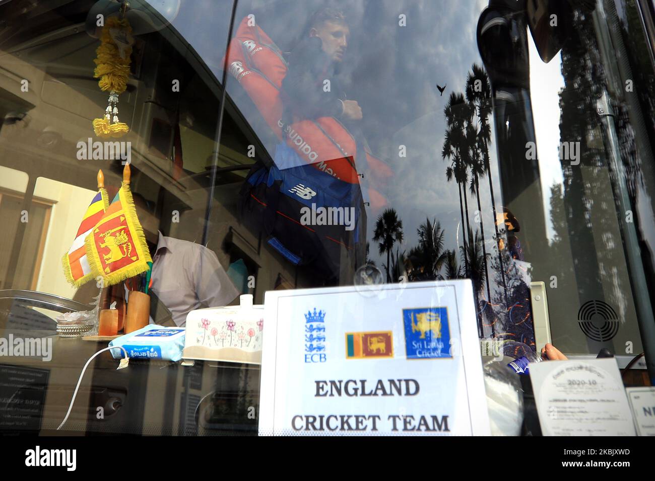 England cricket team's captain Joe Root is seen through the reflection on the front windshield glass after getting in to the bus following the the 2nd practice cricket match between Sri Lanka's Board President's XI and England cricket team at P Sara Oval was canceled on March 13, 2020 in Colombo, Sri Lanka. England cricket team's tour of Sri Lanka was officially called off due to the global spread of the coronavirus. The decision was announced by the England and Wales Cricket Board and their Sri Lankan counterparts on Friday morning while Joe Root’s players were out in the middle playing the s Stock Photo
