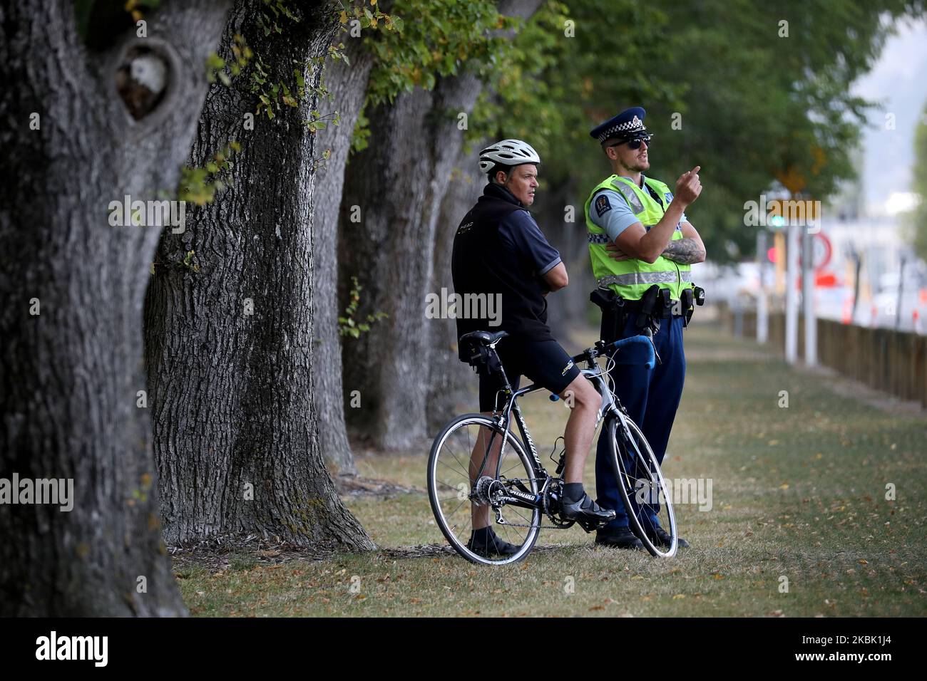 A cyclist talks with a police officer outsideÂ the Al Noor mosque in Christchurch, New Zealand on March 15, 2020. On March 15 last year, 51 people died and 49 were injured in the shootings at Christchurch's Al Noor and Linwood MosquesÂ when a gunman opened fire on worshippers.Â It was labeled as New Zealand's 'darkest day'.Â Events around the country including the Christchurch National Remembrance Service which marking the first anniversary of the attacks has been canceled amid safety fears over Covid-19.Â (Photo by Sanka Vidanagama/NurPhoto) Stock Photo