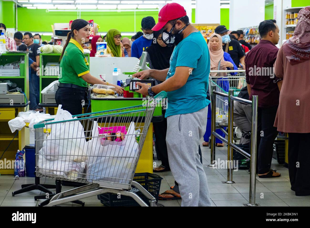 Malaysian Grocery Shoppers in a shopping frenzy at a Vegetable