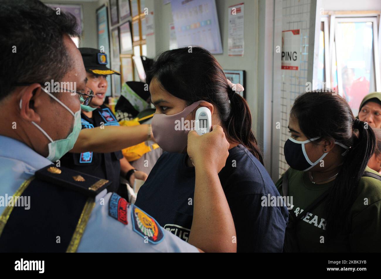 Officers check the temperatures of the visitors of the Cipinang Narcotics prison in Jakarta, Indonesia, on March 16, 2020 for preventing the diffusion of Coronavirus (Covid-19). (Photo by Dasril Roszandi/NurPhoto) Stock Photo