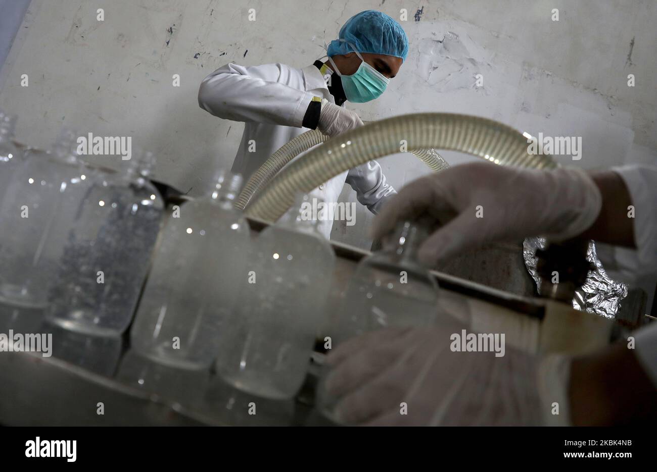 Palestinian workers work on the production line of sterilizing gel at a cleaning materials factory in the southern Gaza Strip city of Rafah, March 17, 2020. Gaza authorities declared a new set of precautionary measures amid concerns about the spread of the novel coronavirus in the coastal enclave. (Photo by Majdi Fathi/NurPhoto) Stock Photo