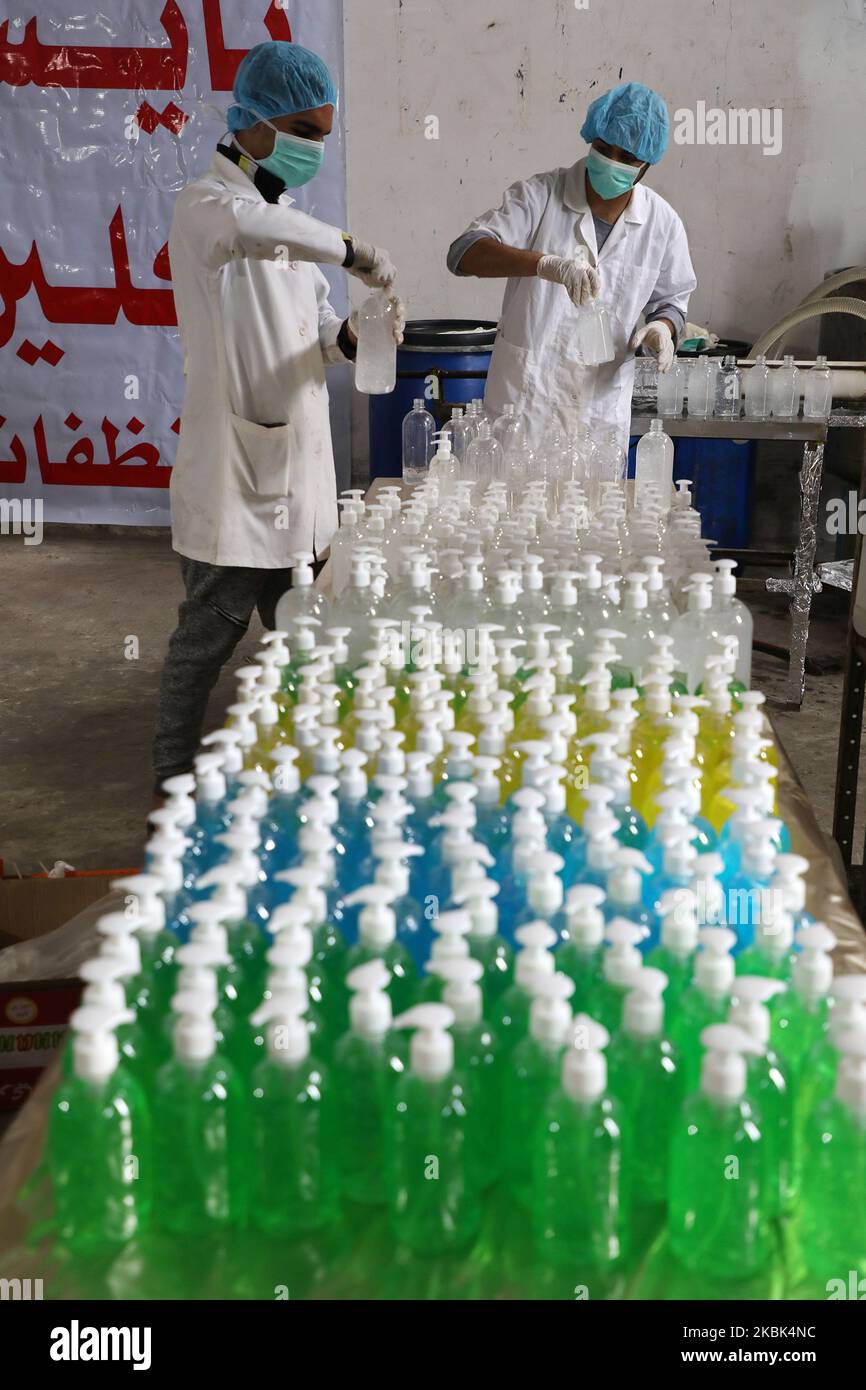 Palestinian workers work on the production line of sterilizing gel at a cleaning materials factory in the southern Gaza Strip city of Rafah, March 17, 2020. Gaza authorities declared a new set of precautionary measures amid concerns about the spread of the novel coronavirus in the coastal enclave. (Photo by Majdi Fathi/NurPhoto) Stock Photo