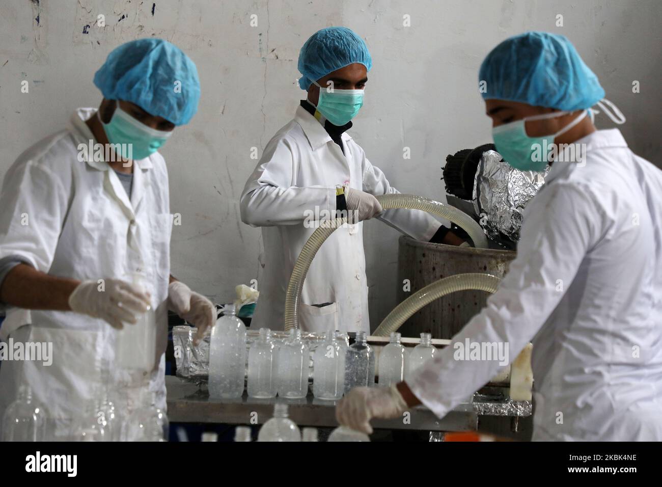 Palestinian workers work on the production line of sterilizing gel at a cleaning materials factory in the southern Gaza Strip city of Rafah, March 17, 2020. Gaza authorities declared a new set of precautionary measures amid concerns about the spread of the novel coronavirus in the coastal enclave. (Photo by Majdi Fathi/NurPhoto) Stock Photo