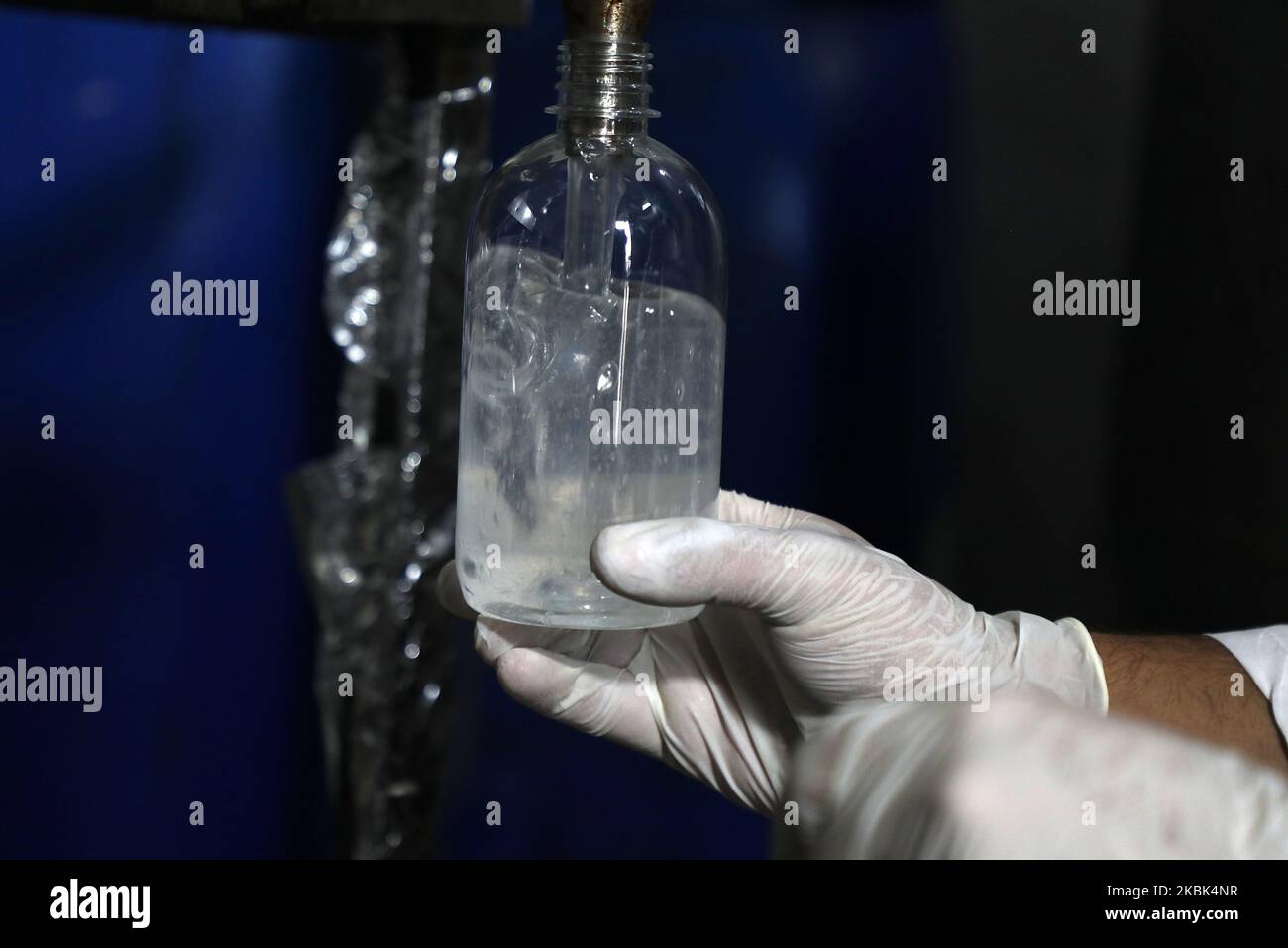 Palestinian workers work on the production line of sterilizing gel at a cleaning materials factory in the southern Gaza Strip city of Rafah, March 17, 2020. Gaza authorities declared a new set of precautionary measures amid concerns about the spread of the novel coronavirus in the coastal enclave. (Photo by Majdi Fathi/NurPhoto) Stock Photo