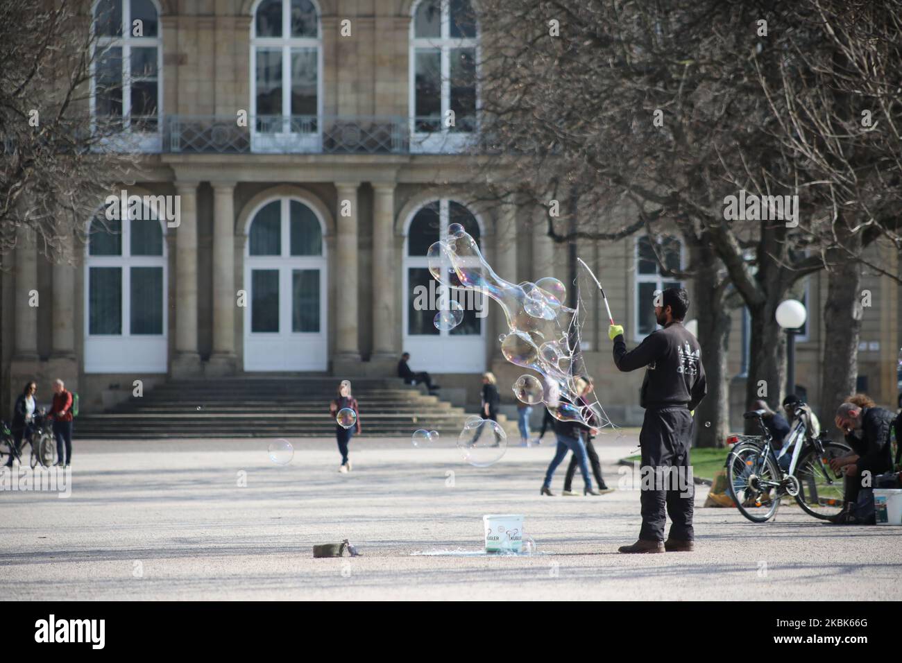 A man releases shampoo bubbles in the center of Stuttgart, southern Germany on March 18, 2020.German leaders urged citizens to stay home, as the government announced unprecedented nationwide measures to radically scale back public life in order to slow the spread of the coronavirus. (Photo by Agron Beqiri/NurPhoto) Stock Photo