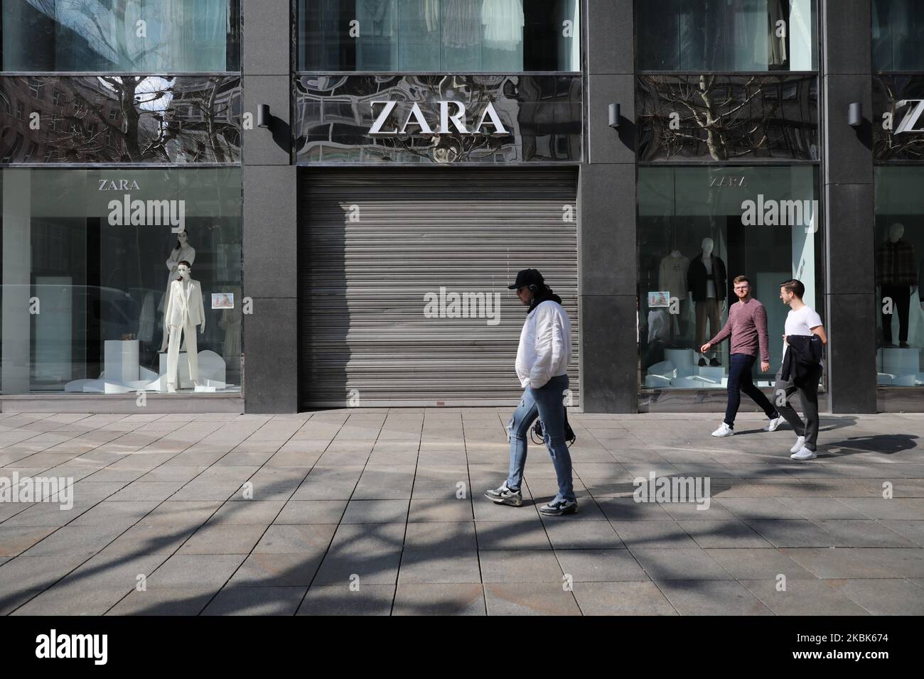People walk in front of closed stores at the center of Stuttgart, southern Germany on March 18, 2020. German leaders urged citizens to stay home, as the government announced unprecedented nationwide measures to radically scale back public life in order to slow the spread of the coronavirus. (Photo by Agron Beqiri/NurPhoto) Stock Photo
