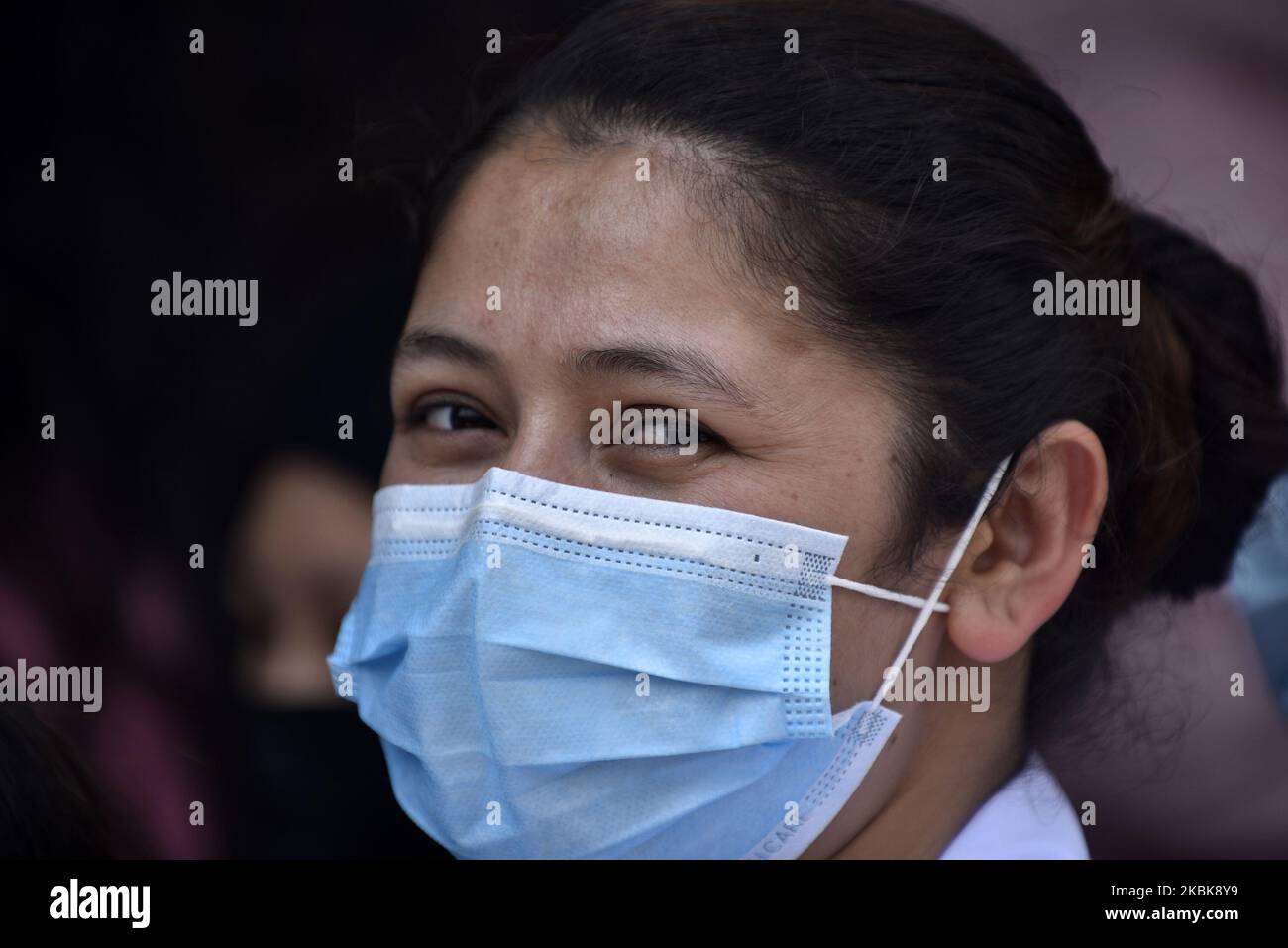 A Portrait of Nepalese people lining to buy surgical masks from the Sajha Shwashthya Sewa, a