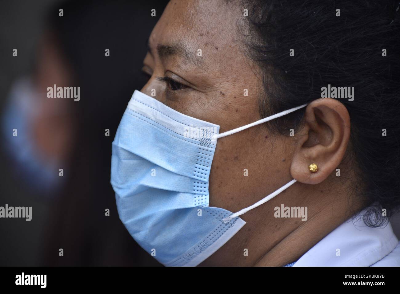 A Portrait of Nepalese people lining to buy surgical masks from the Sajha Shwashthya Sewa, a