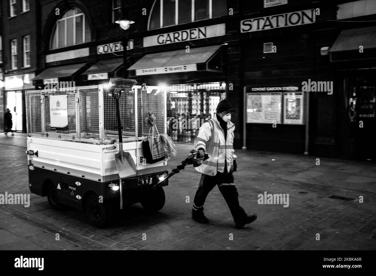 (EDITOR'S NOTE: Image was converted to black and white) A road cleaner is seen at work as he wears a mask outside Covent Garden Station, on March 20, 2020 in London, United Kingdom. British Prime Minister Boris Johnson announced that the country's bars, pubs, restaurants and cafes must close tonight to curb the spread of COVID-19, which has killed more than 100 people in the UK. (Photo by Alberto Pezzali/NurPhoto) Stock Photo