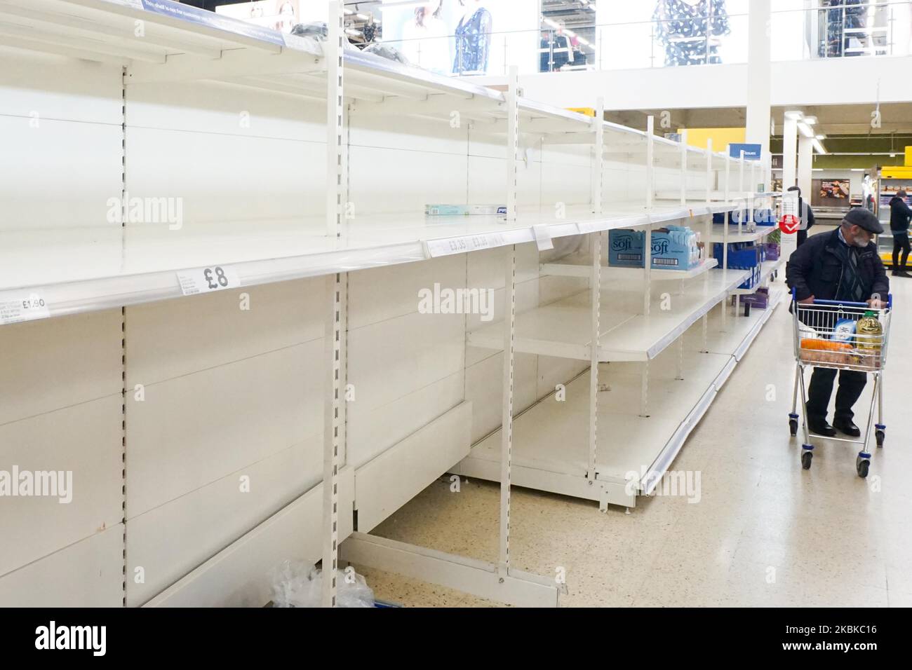 Empty shelves of Tesco supermarket as customers look for food in