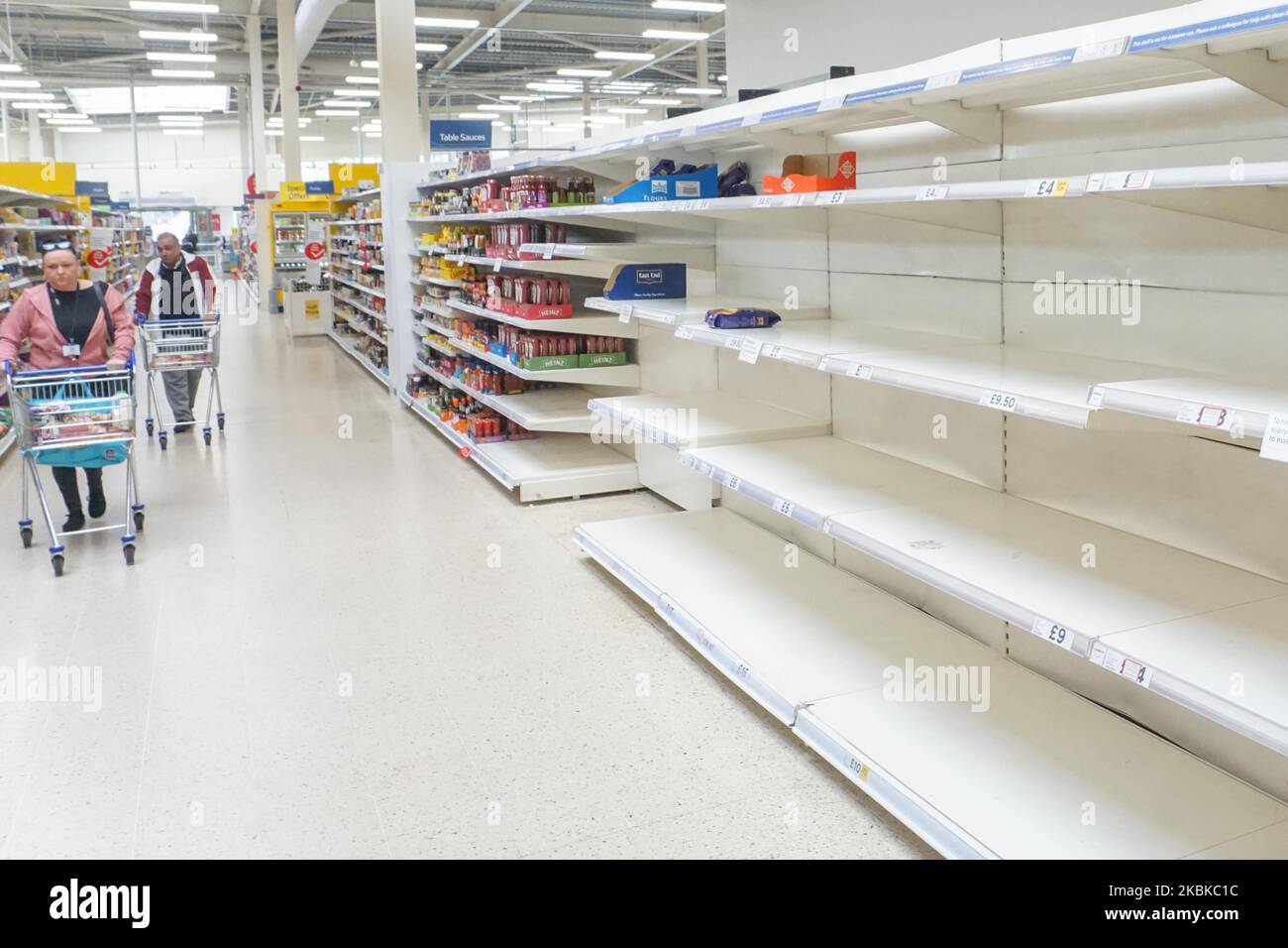 Empty shelves of Tesco supermarket as customers look for food in