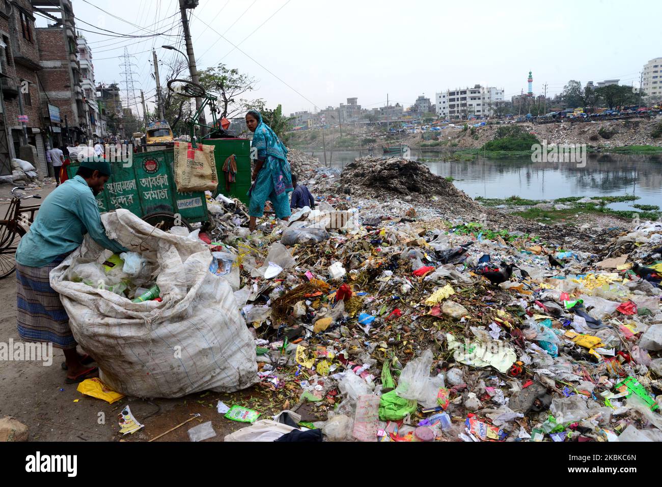 Bangladeshi workers dumping human waste in the polluted Buriganga River