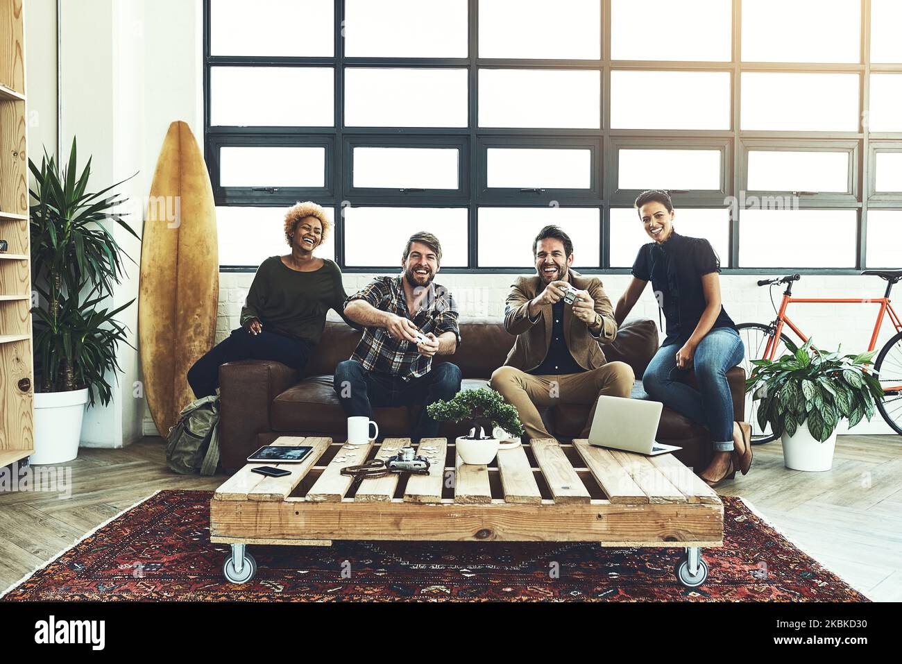 It improves productivity, collaboration, and brain function. a group of designers having fun while playing games. Stock Photo