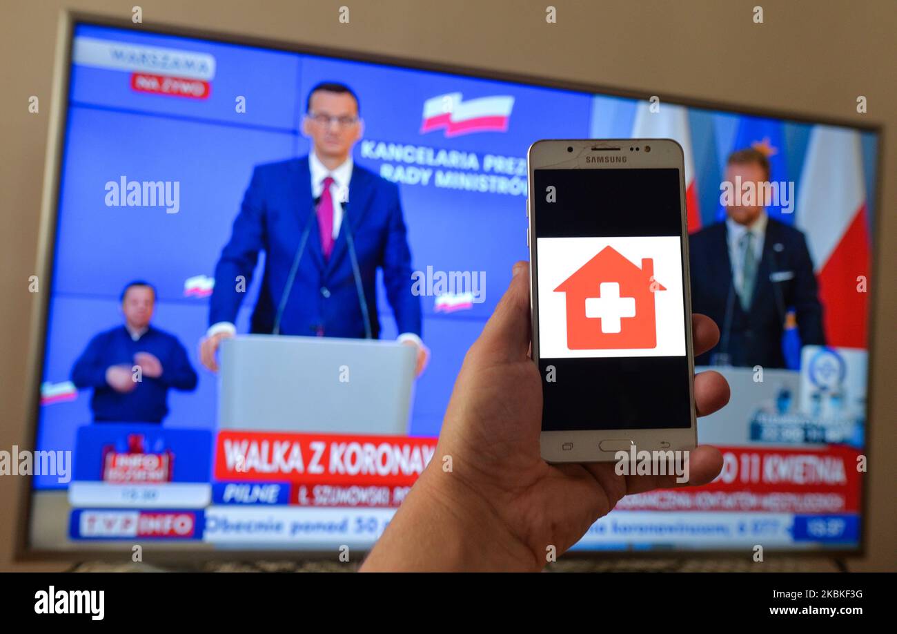 The Home Quarantine app logo seen on Android phone during a televised address by Polish PM Mateusz Morawiecki. Prime Minister Mateusz Morawiecki just announced new stringent restrictions in the movement and contacts between people. WIth over 775 cases of coronavirus in Poland and 9 deaths, the Polish government introduces new restrictions for the population. On Tuesday, March 24, 2020, in Krakow, Poland. (Photo by Artur Widak/NurPhoto) Stock Photo