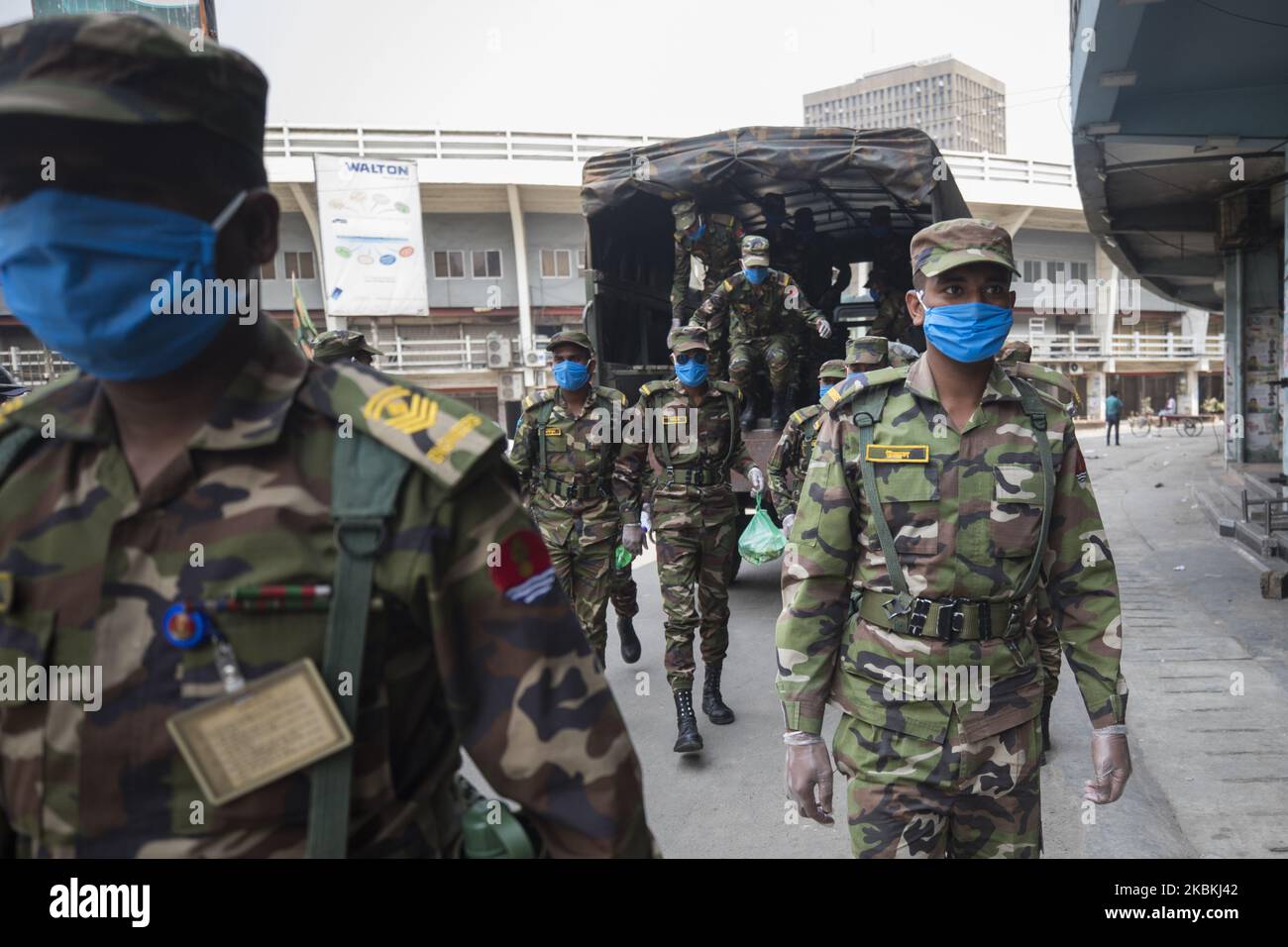 Bangladesh Army personals get down from a army truck to enter a makeshift camp in Bangabandhu National Stadium in Dhaka on March 26, 2020. (Photo by Ahmed Salahuddin/NurPhoto) Stock Photo