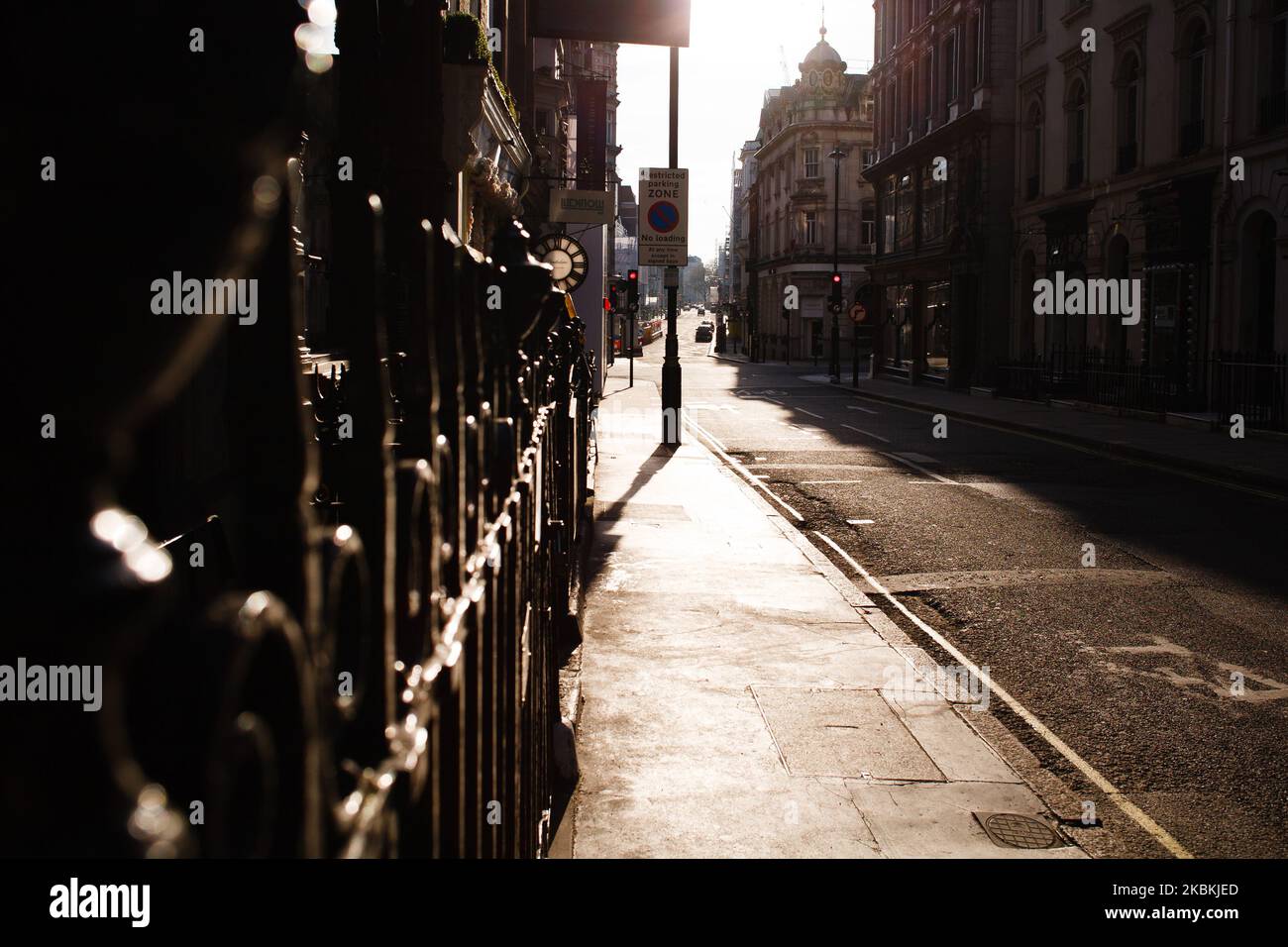 Late afternoon sunlight shines on a deserted Maddox Street in the upmarket Mayfair district of London, England, on March 26, 2020. According to the latest daily figures a total of 578 people have so far died across the UK after testing positive for the covid-19 coronavirus. Hospitals in London, where around a third of cases have been diagnosed, are under particular strain. One senior hospital figure, Chris Hopson of the group NHS Providers, warned today of a 'tsunami' of cases to hit hospitals in the capital over the coming weeks. (Photo by David Cliff/NurPhoto) Stock Photo