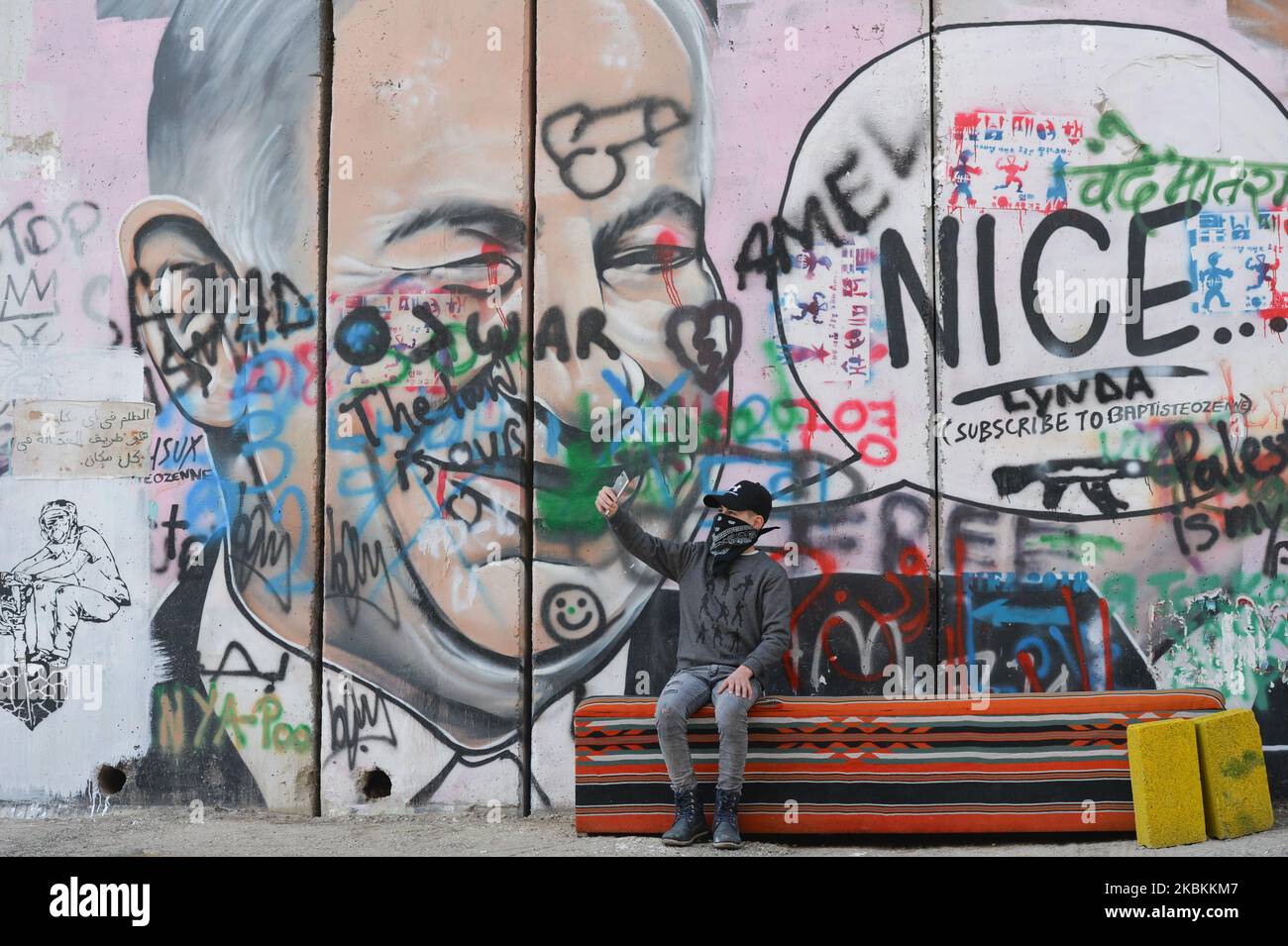 A partial view of a vandalised mural depicting US President Donald Trump and Israel's Prime Minister Benjamin Netanyahu seen among other political and social mural paintings and graffitis on the wall separting Israel and the West Bank in Bethlehem. On Thursday, March 5, 2020, in Bethlehem, Palestine (Photo by Artur Widak/NurPhoto) Stock Photo