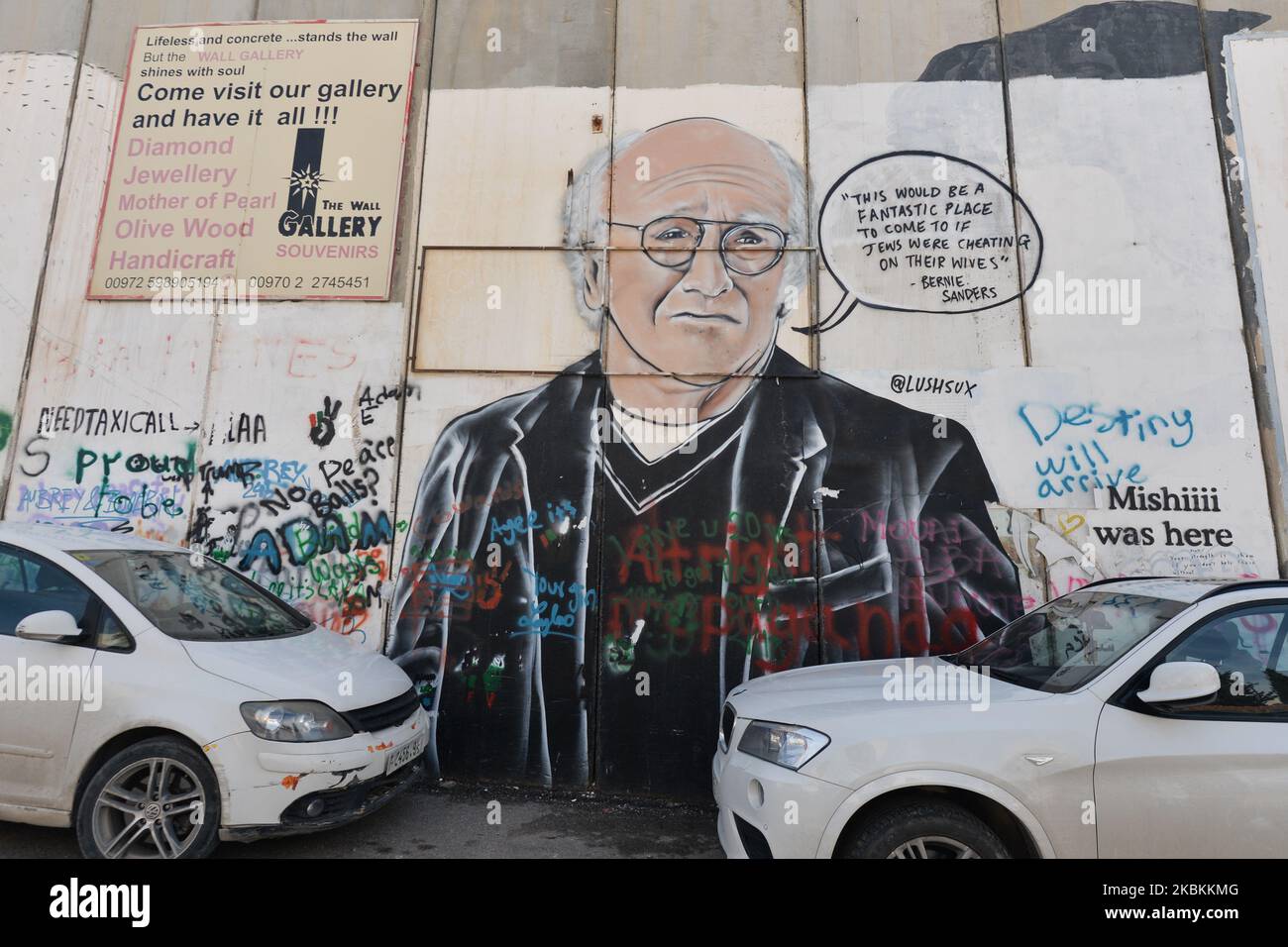 An image of actor Larry David accompanied by a quote by Bernie Sanders among other political and social mural paintings and graffitis on the wall separting Israel and the West Bank in Bethlehem. On Thursday, March 5, 2020, in Bethlehem, Palestine (Photo by Artur Widak/NurPhoto) Stock Photo