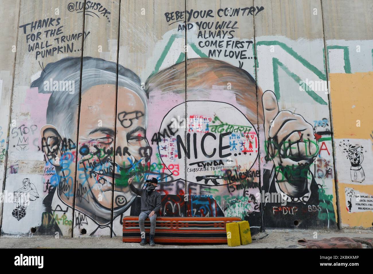 A vandalised mural depicting US President Donald Trump and Israel's Prime Minister Benjamin Netanyahu seen among other political and social mural paintings and graffitis on the wall separting Israel and the West Bank in Bethlehem. On Thursday, March 5, 2020, in Bethlehem, Palestine (Photo by Artur Widak/NurPhoto) Stock Photo