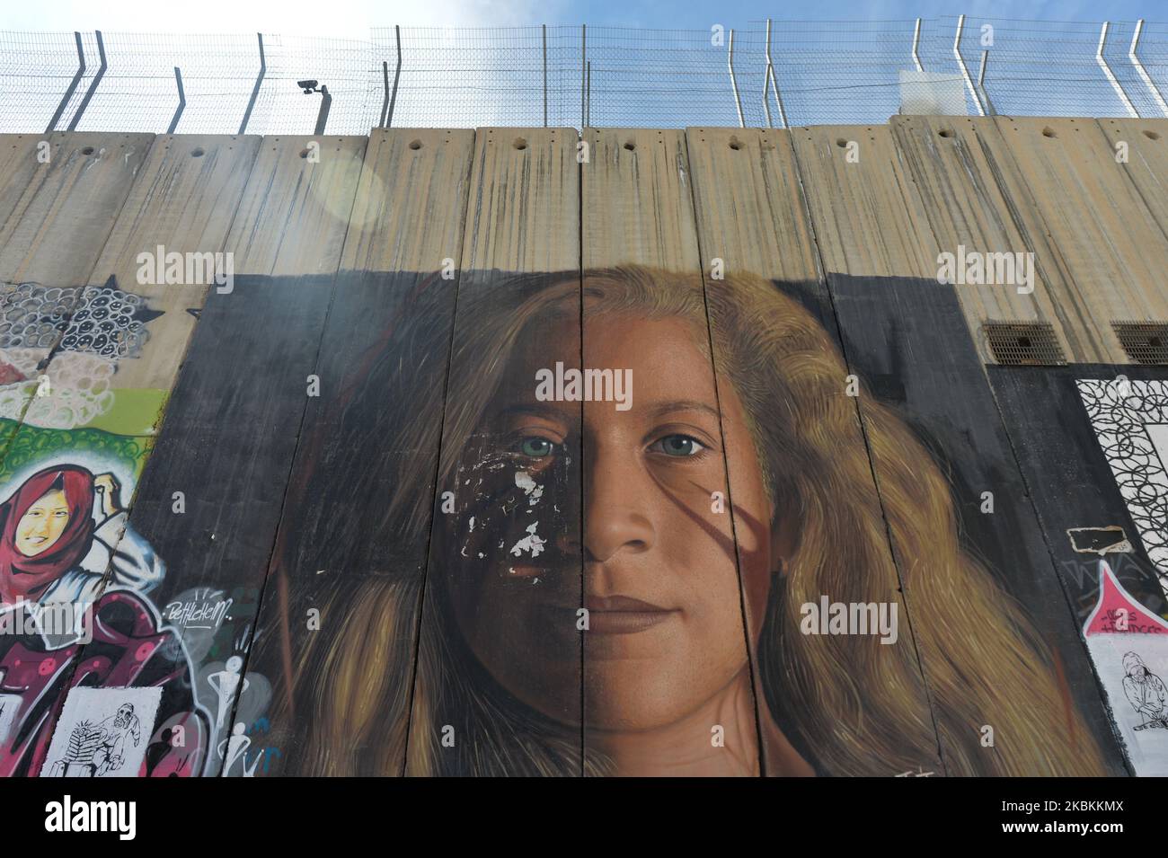 A mural of Palestinian activist and protester Ahed Tamimi seen among other political and social mural paintings and graffitis on the wall separting Israel and the West Bank in Bethlehem. On Thursday, March 5, 2020, in Bethlehem, Palestine (Photo by Artur Widak/NurPhoto) Stock Photo
