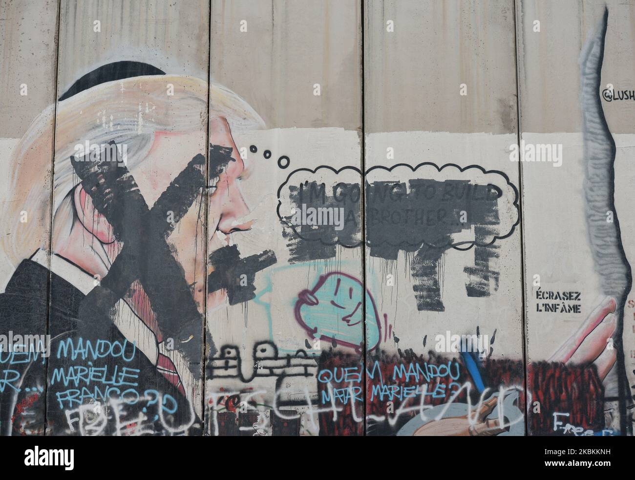 Vandalised mural depicting US President Donald Trump seen among other political and social mural paintings and graffitis on the wall separting Israel and the West Bank in Bethlehem. On Thursday, March 5, 2020, in Bethlehem, Palestine (Photo by Artur Widak/NurPhoto) Stock Photo