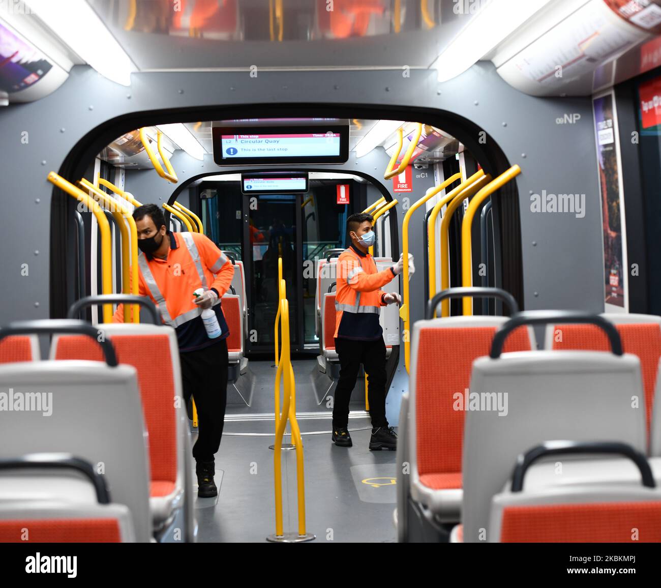 Tram cleaning crew seen sanitising handrails on a Sydney Tram at