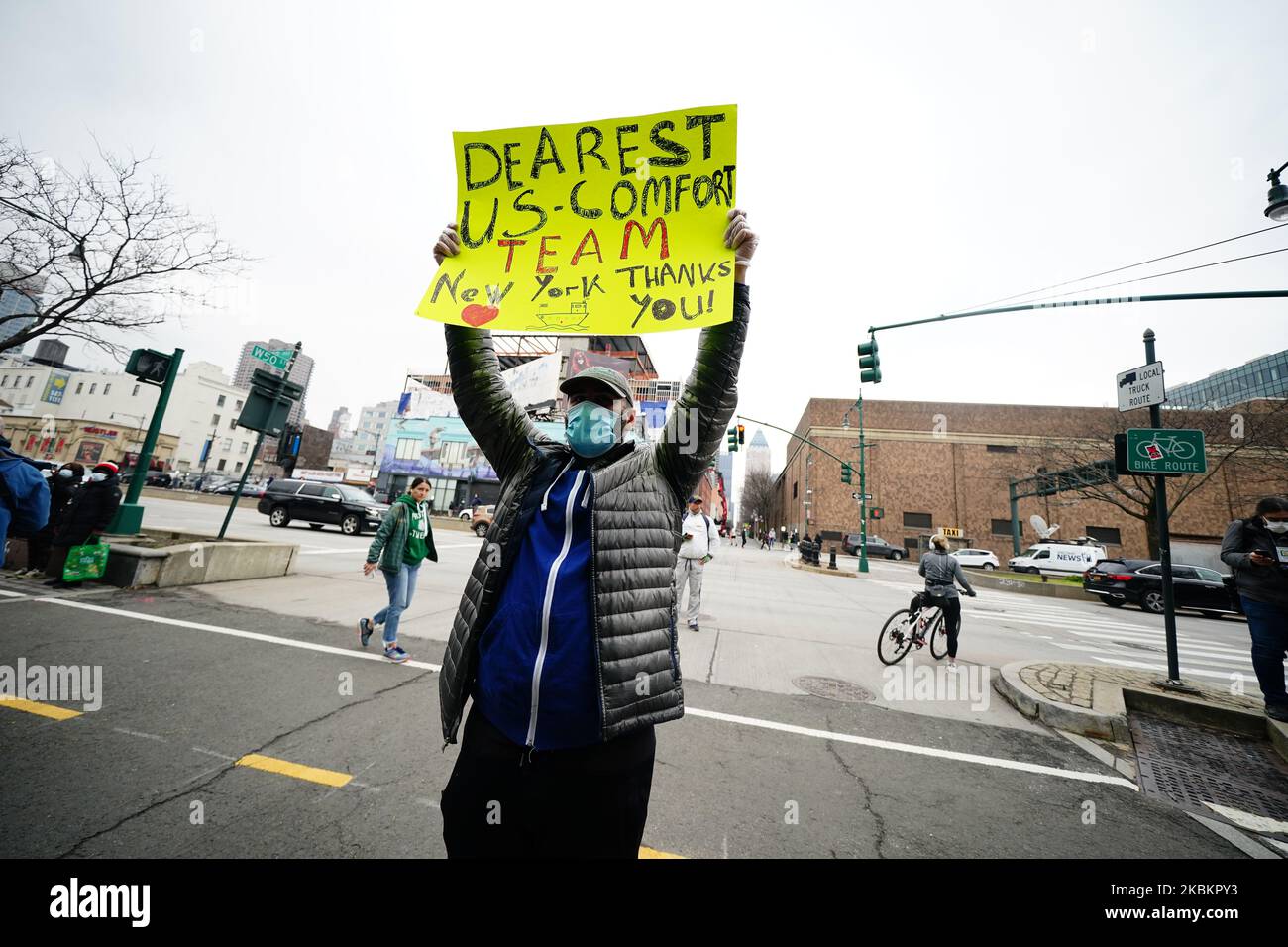 A man seen holding a sign to thank US Navy hospital ship Comfort team